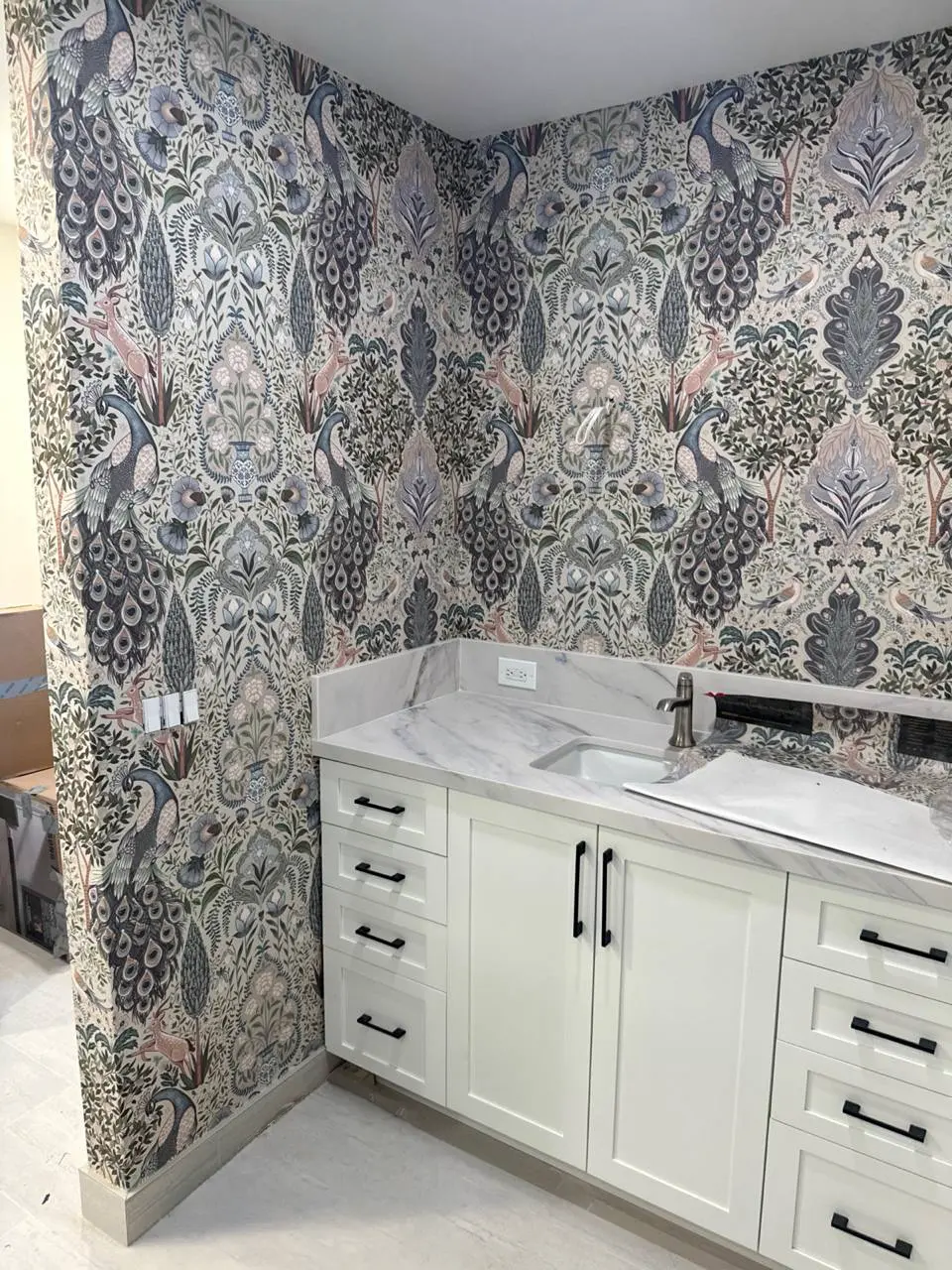 Peacock wallpaper installation in a Los Angeles bathroom vanity