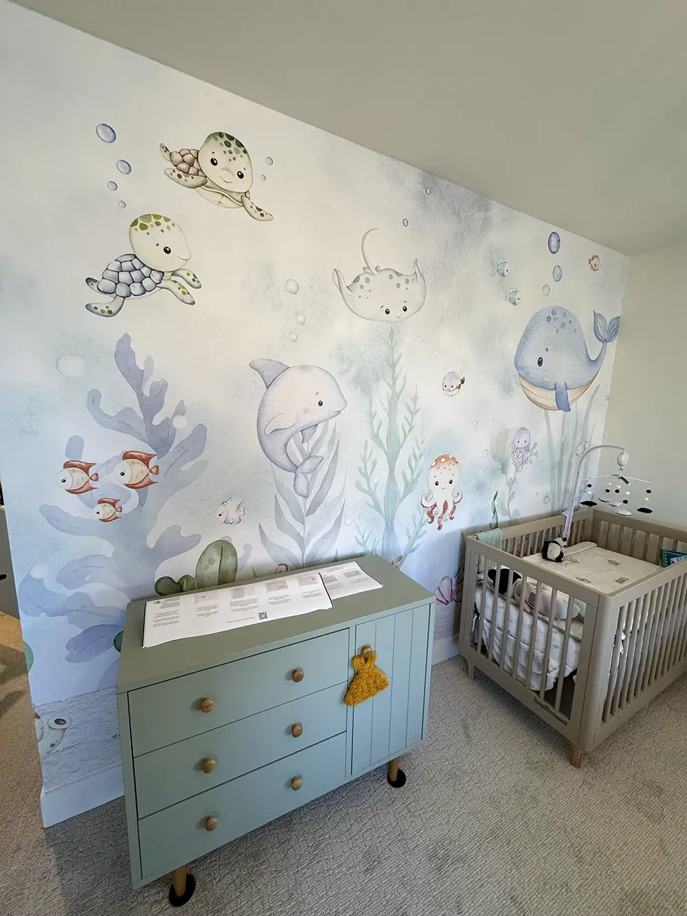 Underwater mural wallpaper installation in a Los Angeles nursery